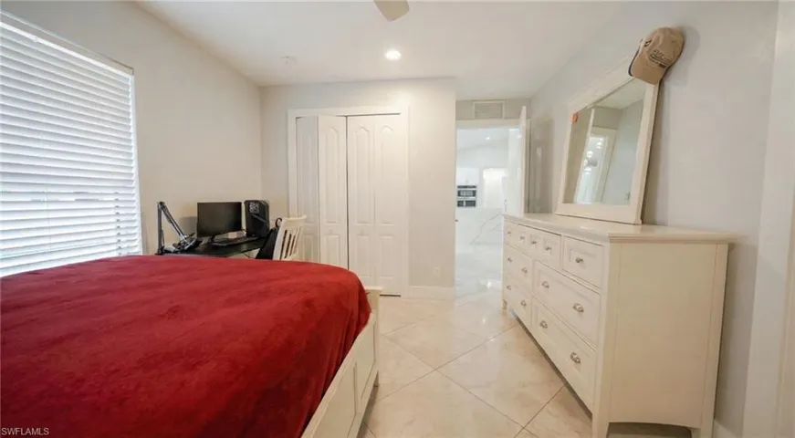 Bedroom featuring a closet, ceiling fan, recessed lighting, and light tile patterned floors