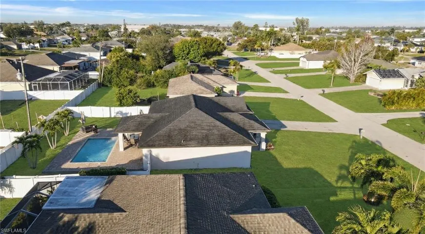 Aerial perspective of suburban area with a pool