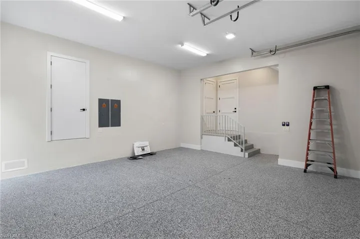 Large Garage with 3 Storage Closets.  1 for HVAC, 1 atop the stairs for personal items, 1 Huge Closet behind the ladder wall for Storage