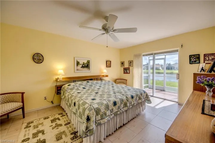 Tiled Master Bedroom featuring ensuite bath and sliding doors to lanai.