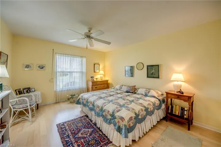 Spacious Guest Bedroom with ceiling fan and laminate floors.
