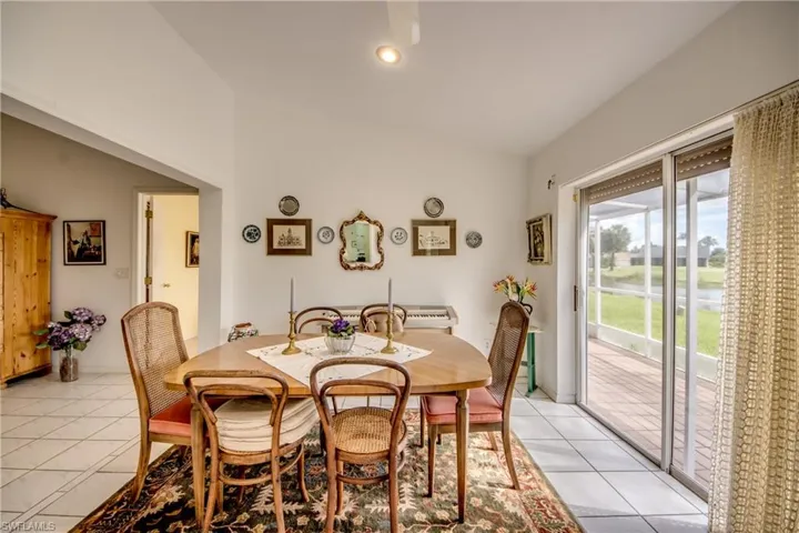 Formal Dining Room overlooking Lake and Golf Course, featuring a healthy amount of sunlight and light tile flooring