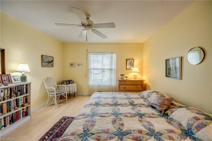 Bedroom featuring ceiling fan and laminate flooring.