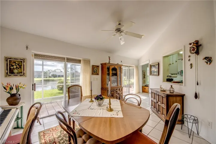 Tiled dining area with ceiling fan and lofted ceiling. Sliding Doors to Lanai.