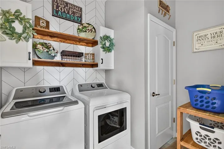 Washroom with cabinet space and washer and dryer