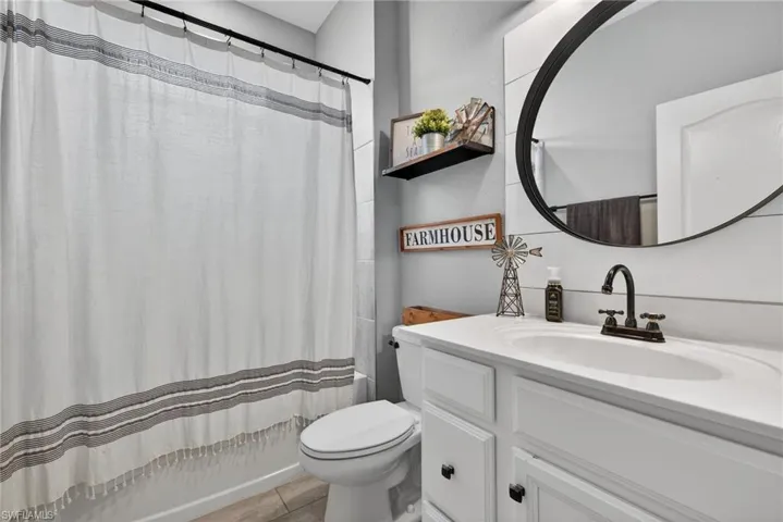 Full bathroom with vanity and shower / bath combo with shower curtain
