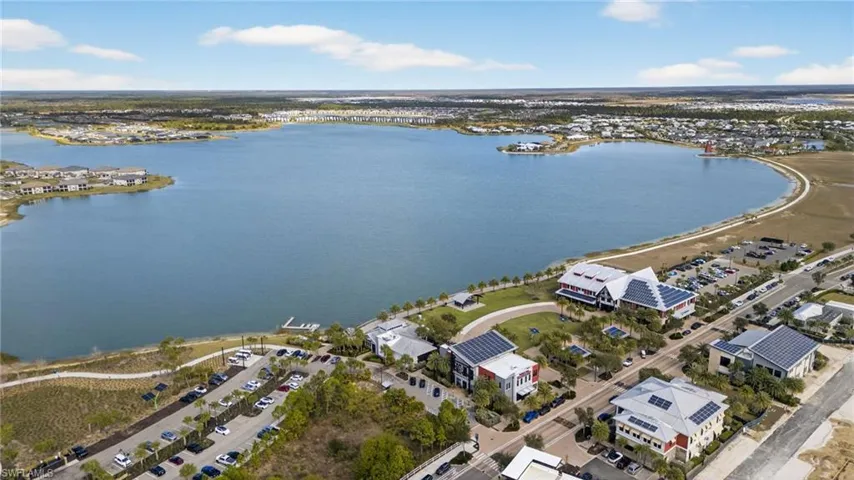View of property location with a nearby body of water and nearby suburban area