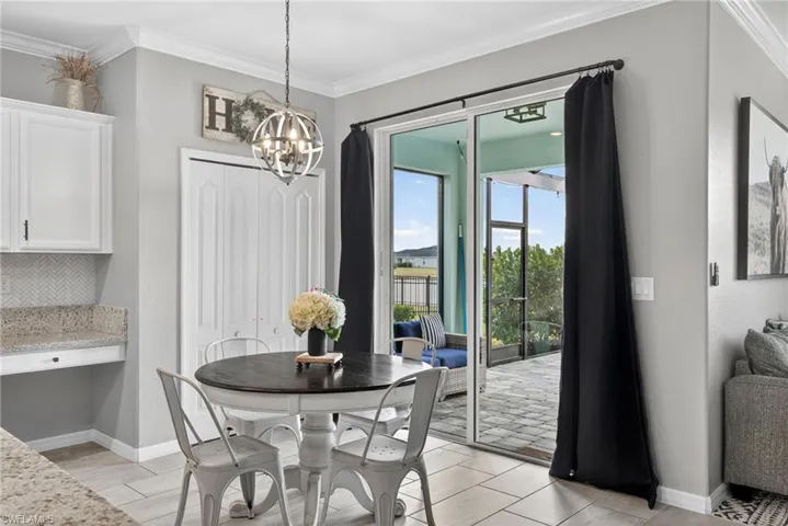Dining room featuring crown molding and a chandelier