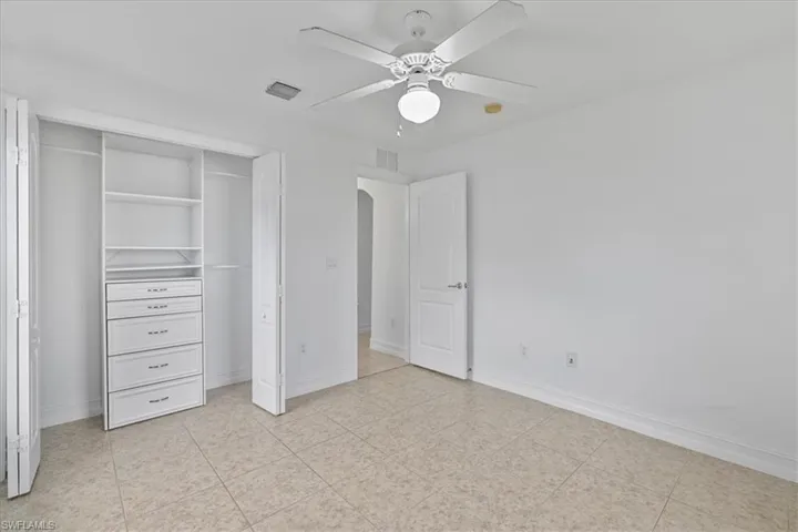 Unfurnished bedroom featuring a closet and ceiling fan