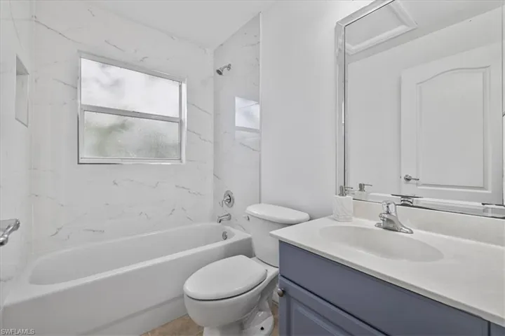 Bathroom with vanity and bathing tub / shower combination