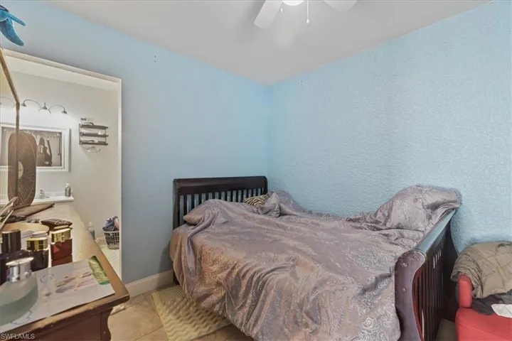 Bedroom featuring tile patterned flooring and a ceiling fan