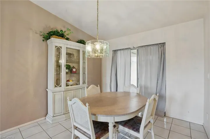 Dining area with light tile patterned floors