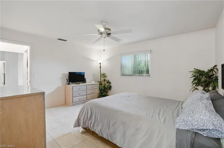Master bedroom with walk-in closet, ceiling fan and en-suite bathroom