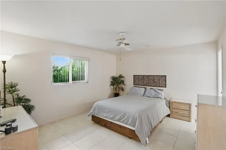 Master bedroom with walk-in closet, ceiling fan and en-suite bathroom