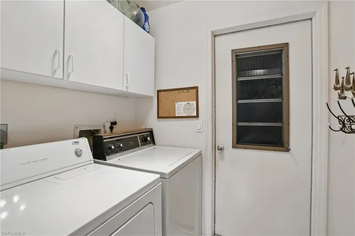 In residence laundry room with cabinet space