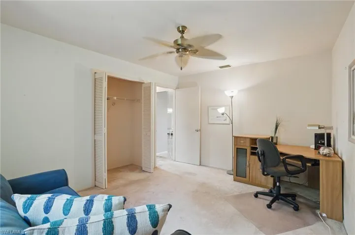 Home office/Guest bedroom with carpet, closet and ceiling fan