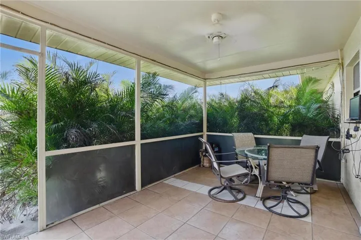 Lanai with outdoor dining area and ceiling fan