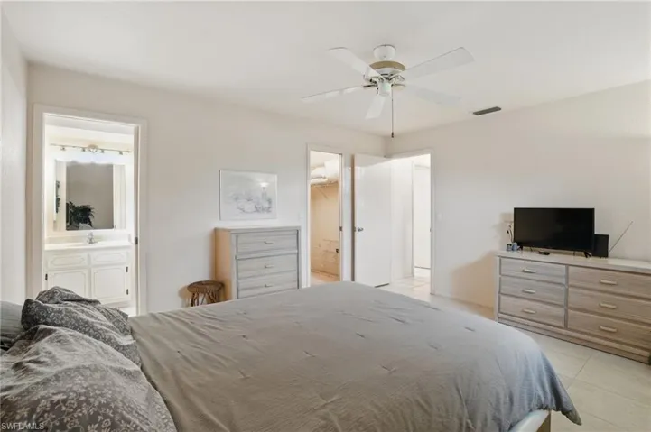 Master bedroom with walk-in closet, ceiling fan and en-suite bathroom