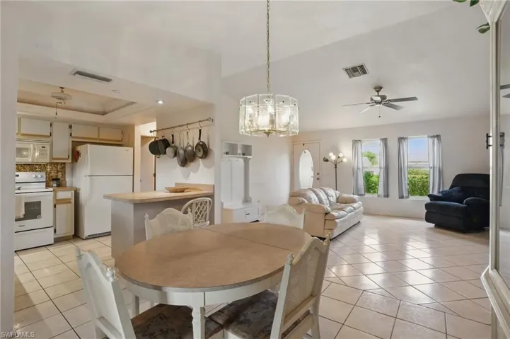 Dining area with light tile patterned floors