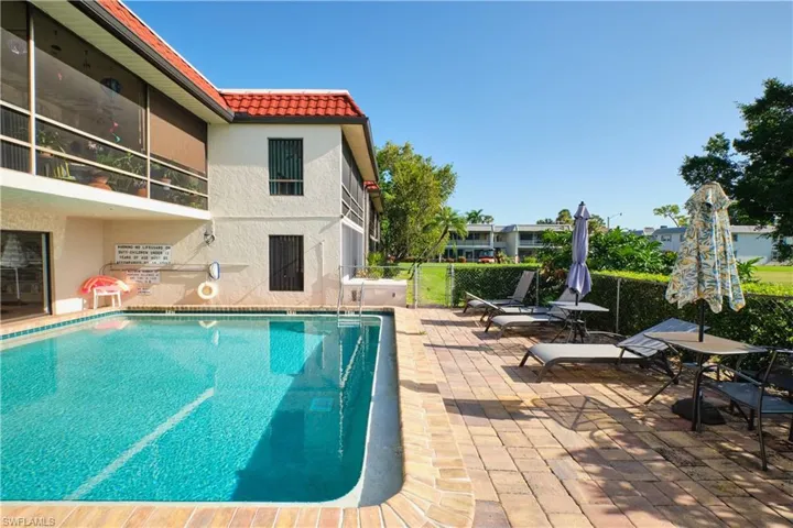 Community pool with a patio