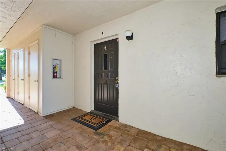 Doorway to property with stucco siding