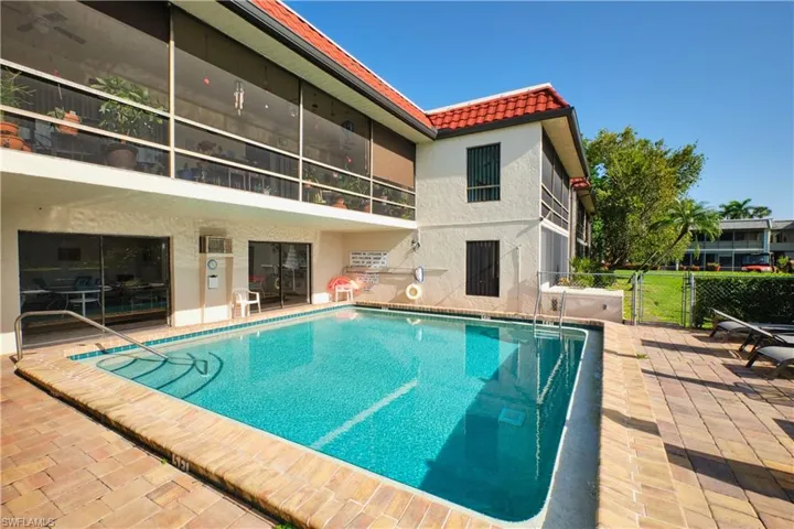 Community pool featuring a patio