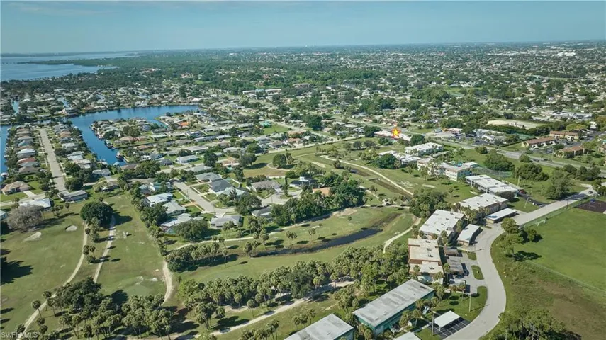 Aerial overview of property's location with a nearby body of water and nearby suburban area