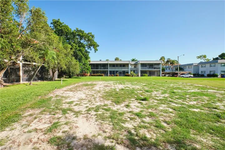 View of home's community with a lawn