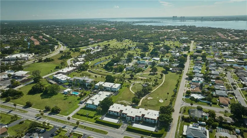 View of property location featuring a nearby body of water and nearby suburban area