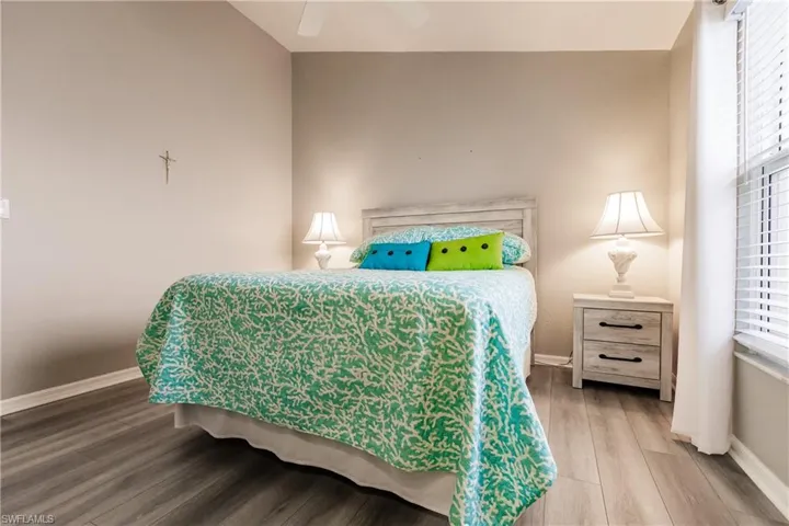 Bedroom with hardwood / wood-style floors and ceiling fan