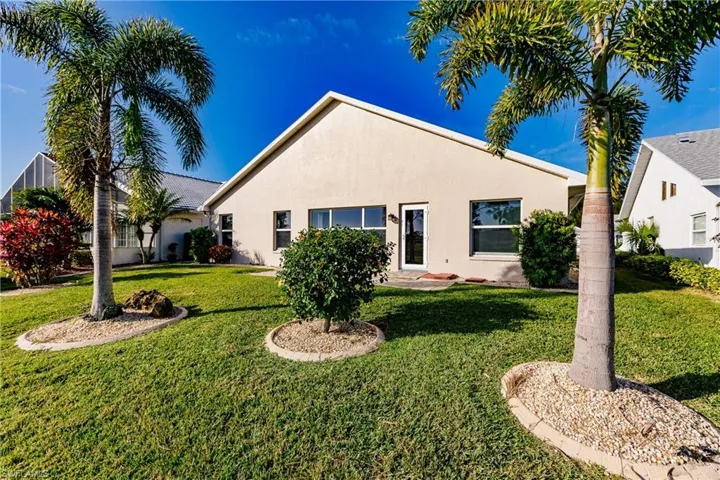 Rear view of house featuring a yard