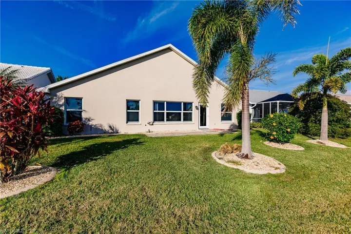 Back of house featuring a yard