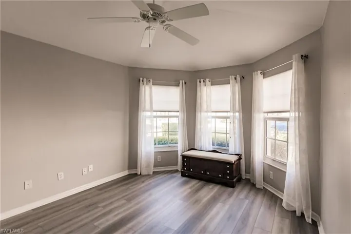 Unfurnished room featuring ceiling fan and hardwood / wood-style flooring