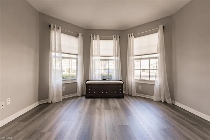 Spare room featuring dark wood-type flooring