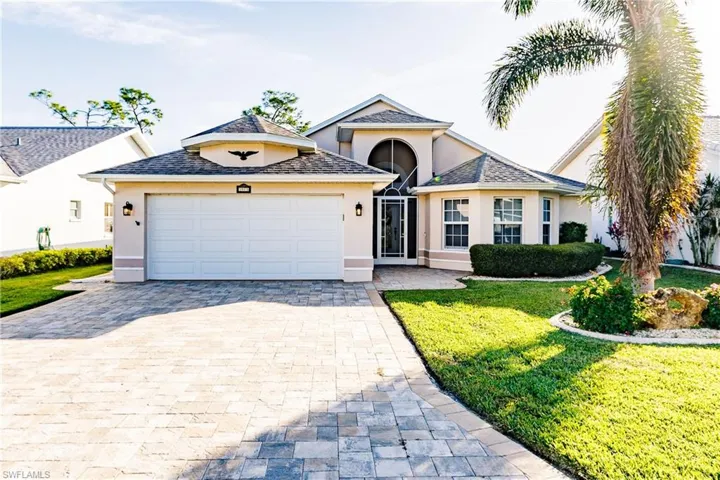 View of front of house featuring a front yard and a garage