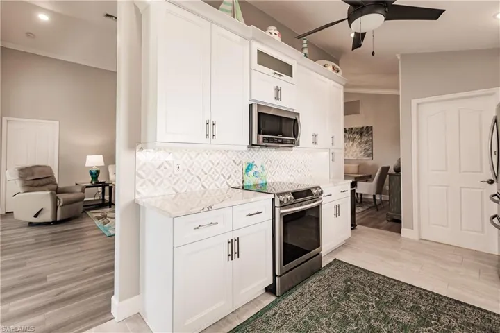 Kitchen featuring white cabinets, appliances with stainless steel finishes, and light hardwood / wood-style flooring