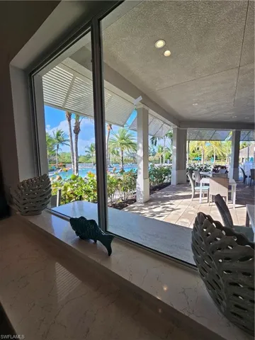VIEW OF THE COMMUNITY PATIO AND POOL FROM THE COMMUNITY LOUNGE
