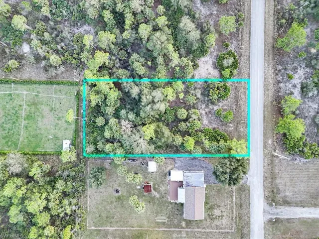 Aerial view of property and surrounding area with property parcel outlined