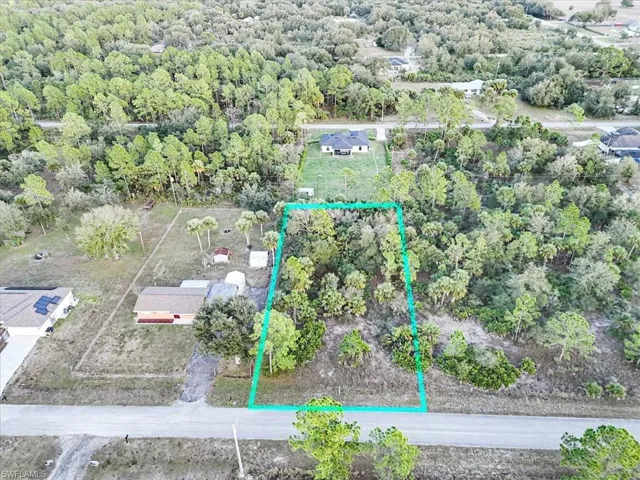 View of property location with property boundaries highlighted and a forest