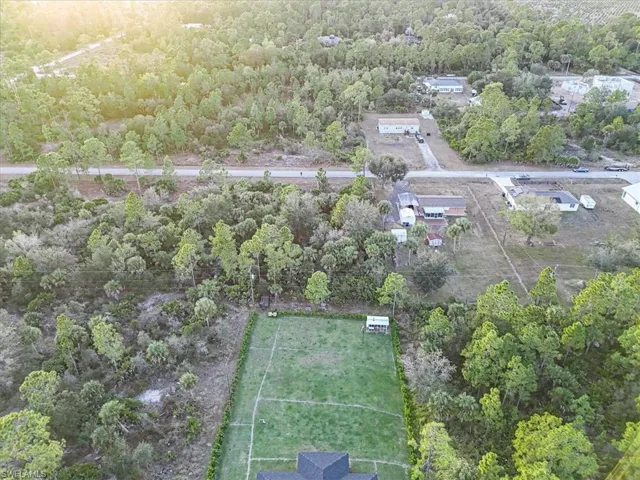 Aerial overview of property's location featuring a forest