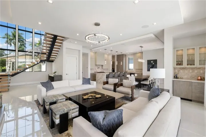 Living area with hanging lights and light tile patterned flooring