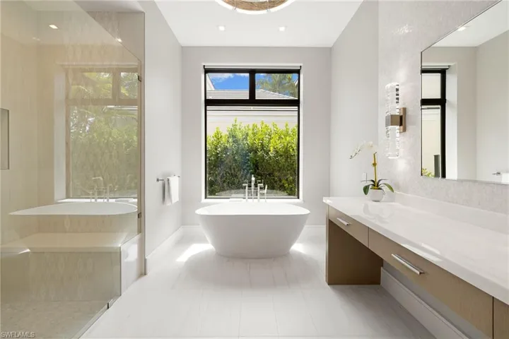 Bathroom featuring a soaking tub, vanity, walk in shower, and recessed lighting