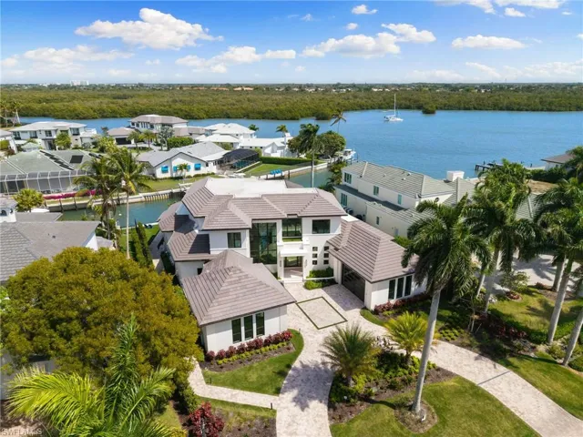 Aerial perspective of suburban area featuring a large body of water