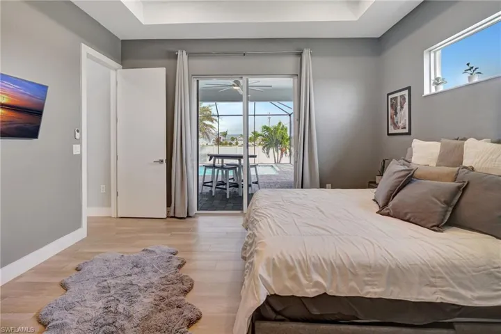 Large primary bedroom w/ impact sliders to lanai.