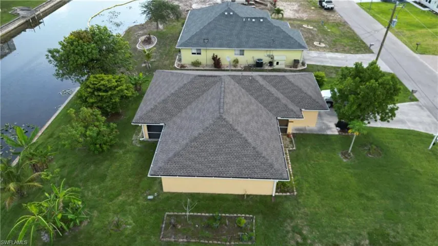Aerial view of property and surrounding area featuring a large body of water