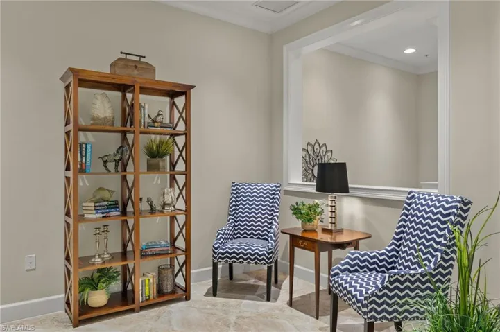 Sitting room featuring light tile patterned floors and ornamental molding