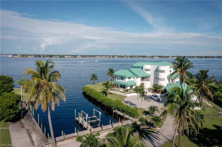 Water view featuring boat lift and a dock