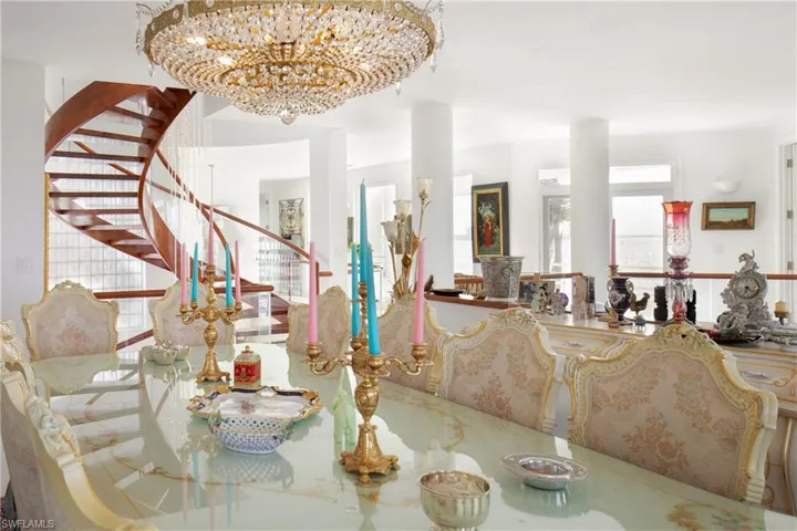 Dining space with stairway and a chandelier
