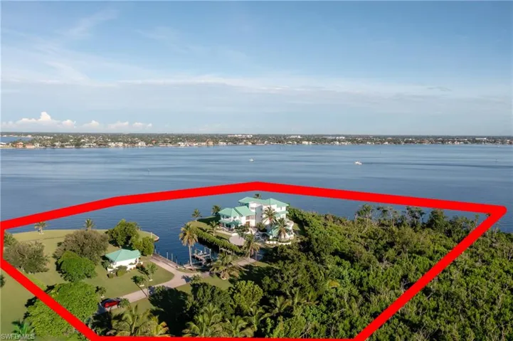 Aerial view of property's location featuring a nearby body of water and property parcel outlined
