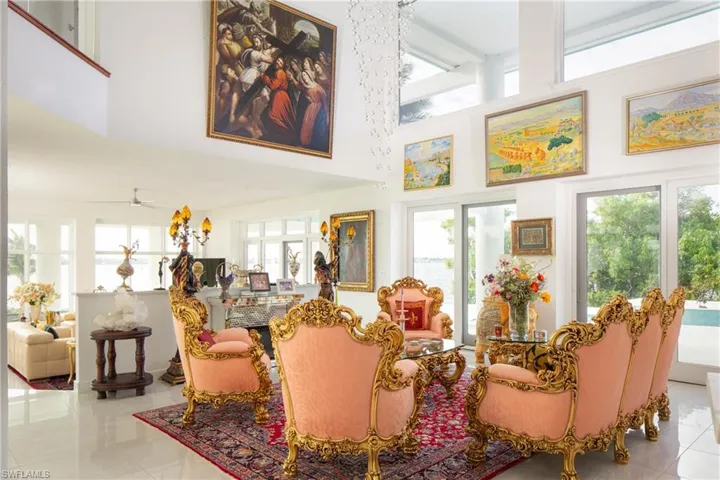 Tiled living room with a towering ceiling and ceiling fan